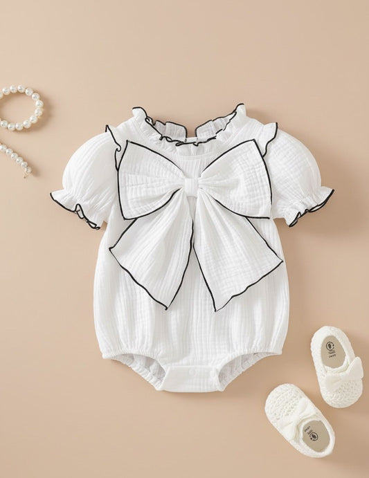 Organic muslin cotton bodysuit with a statement bow